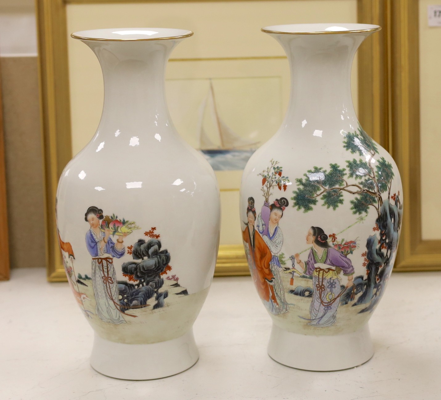 A pair of Chinese famille rose vases, 40 cms high.